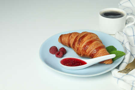 Concept of delicious food with croissant with raspberry jam on white backgroundの写真素材
