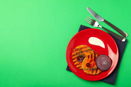 Concept of tasty food with baked pumpkin on green background.の写真素材