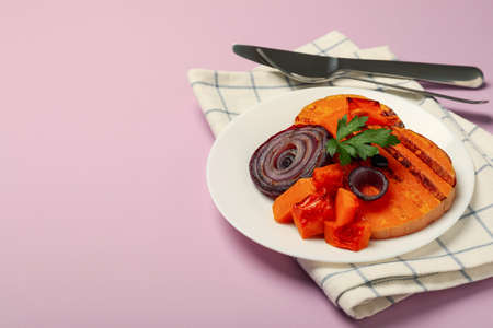 Concept of tasty food with baked pumpkin on violet background.の写真素材