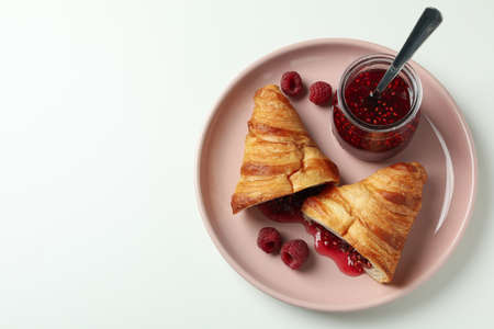 Concept of delicious food with croissant with raspberry jam on white backgroundの写真素材