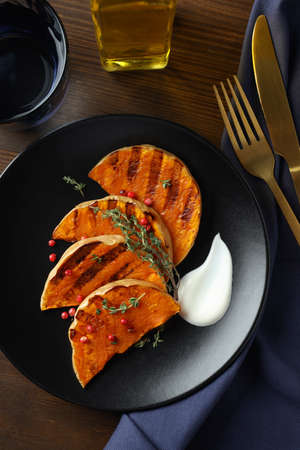 Concept of tasty eating with baked pumpkin on wooden background.の写真素材