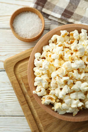Concept of homemade salt popcorn on white wooden background.の写真素材
