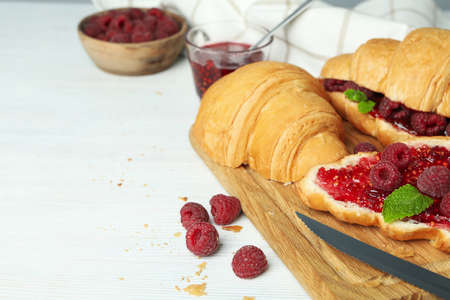 Concept of delicious food with croissants with raspberry jam on white wooden backgroundの写真素材