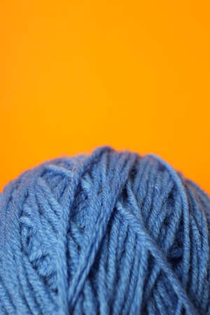 Blue ball of yarn on orange background.の写真素材