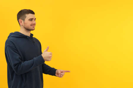 Young man on yellow background, space for text.の写真素材