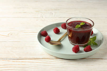 Concept of tasty food with raspberry jam on white wooden backgroundの写真素材