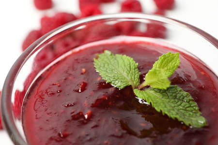 Bowl of raspberry jam, close up and selective focus