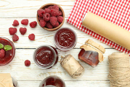 Concept of cooking raspberry jam on white wooden table.の写真素材
