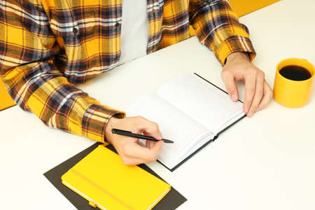 Workplace concept with young man working on table.