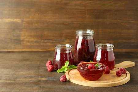 Concept of tasty food with raspberry jam on wooden backgroundの写真素材