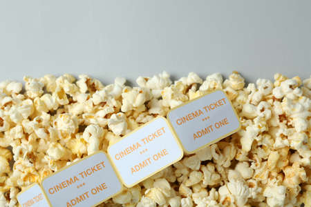 Popcorn with tickets on light gray background, space for text.の写真素材