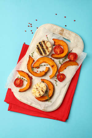 Concept of tasty food with baked pumpkin on blue background.の写真素材