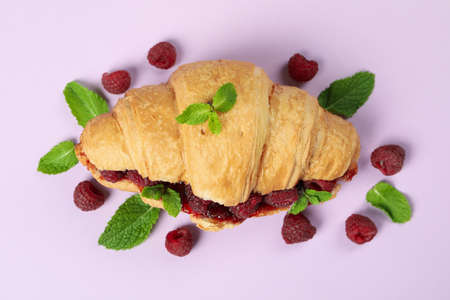 Croissant with raspberry jam on purple backgroundの写真素材