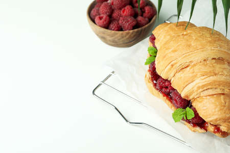 Concept of delicious food with croissant with raspberry jam on white backgroundの写真素材