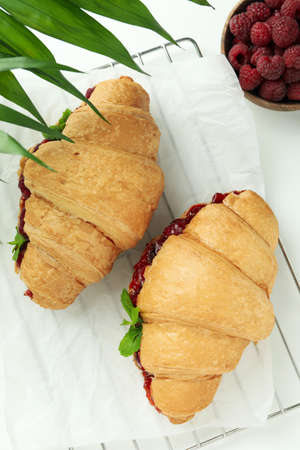Concept of delicious food with croissants with raspberry jam on white backgroundの写真素材