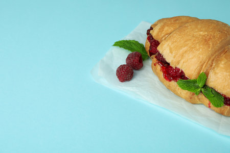 Croissant with raspberry jam on blue backgroundの写真素材