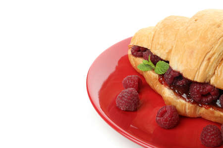 Plate with croissant with raspberry jam isolated on white backgroundの写真素材