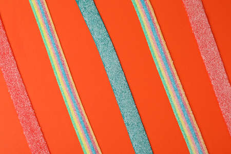 Tasty gummy candies on red background, top view.の写真素材