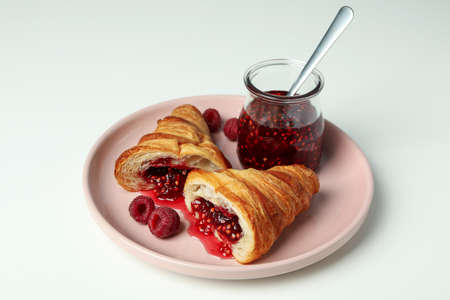 Concept of delicious food with croissant with raspberry jam on white backgroundの写真素材