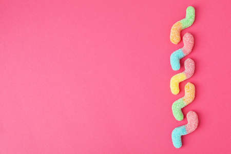 Gummy candies on pink background, space for text.の写真素材