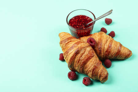 Croissants with raspberry jam on mint backgroundの写真素材