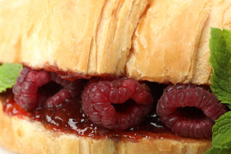Croissant with raspberry jam on all over backgroundの写真素材