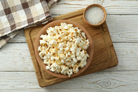 Concept of homemade salt popcorn on white wooden background.の写真素材