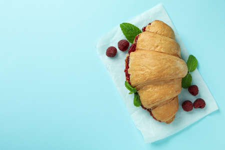Croissant with raspberry jam on blue backgroundの写真素材