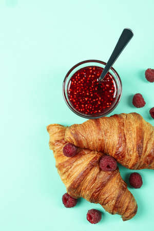 Croissants with raspberry jam on mint backgroundの写真素材