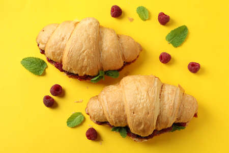 Croissants with raspberry jam on yellow backgroundの写真素材