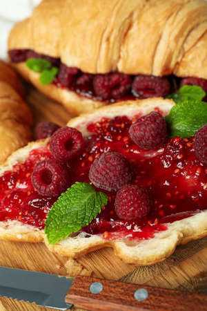 Concept of delicious food with croissants with raspberry jam, close upの写真素材