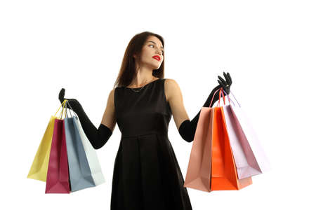 Girl with multicolored paper bags isolated on white background.の写真素材