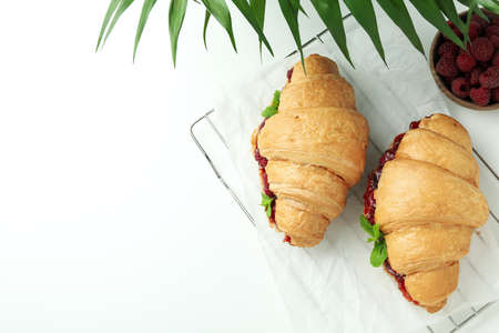 Concept of delicious food with croissants with raspberry jam on white backgroundの写真素材
