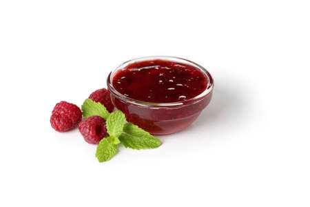 Glass bowl of raspberry jam isolated on white backgroundの写真素材