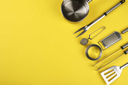 Kitchen utensil on yellow background, space for text.の写真素材