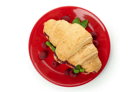 Plate with croissant with raspberry jam isolated on white backgroundの写真素材