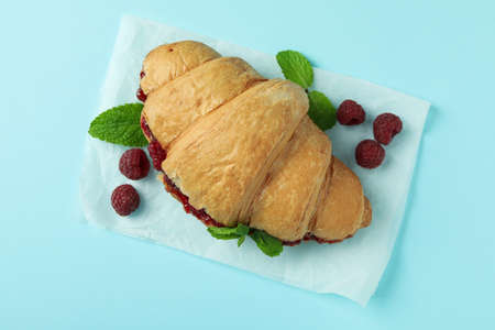 Croissant with raspberry jam on blue backgroundの写真素材