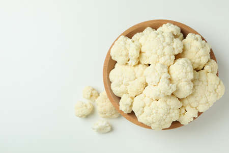 Slices of fresh juicy cauliflower in bowl on white backgroundの写真素材