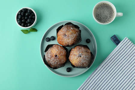 Concept of delicious food with chocolate muffins on mint background.の写真素材