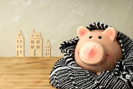 Concept of heating season with piggy bank on wooden table.の写真素材