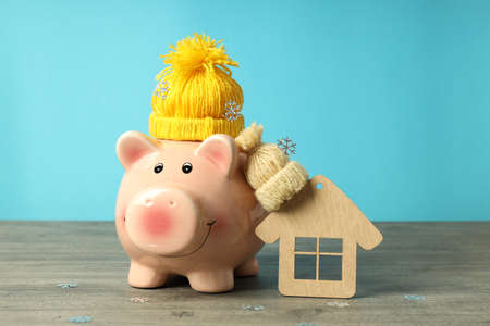 Concept of heating season with piggy bank against blue background.の写真素材