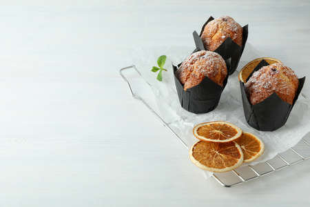 Concept of delicious food with chocolate muffins on white wooden table.の写真素材