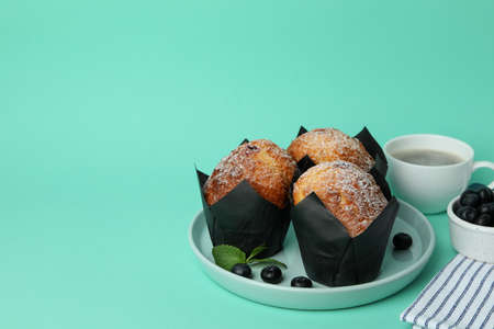 Concept of delicious food with chocolate muffins on mint background.の写真素材