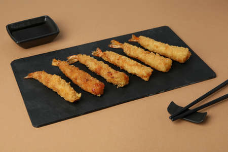 Ð¡oncept of tasty food with deep-fried shrimp on beige backgroundの写真素材