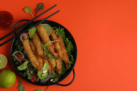 Ð¡oncept of tasty food with deep-fried shrimp on orange backgroundの写真素材