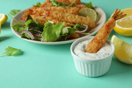 Ð¡oncept of tasty food with deep-fried shrimp on mint backgroundの写真素材
