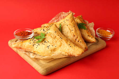 Concept of tasty food with samsa on red backgroundの写真素材