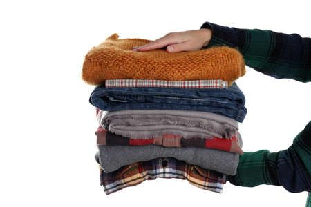 Female hands hold winter clothes, isolated on white background.の写真素材