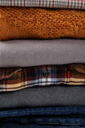 Stack of winter clothes all over background.の写真素材