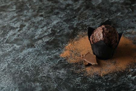 Tasty chocolate muffin on black smokey table.の写真素材